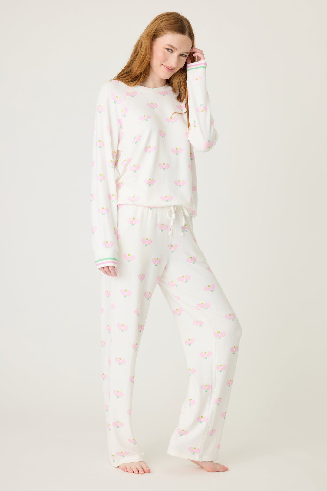 Women's lounge set top & pant in racket printed peachy in ivory-pink pattern, with pink & green stripe waist & sleeve cuffs.