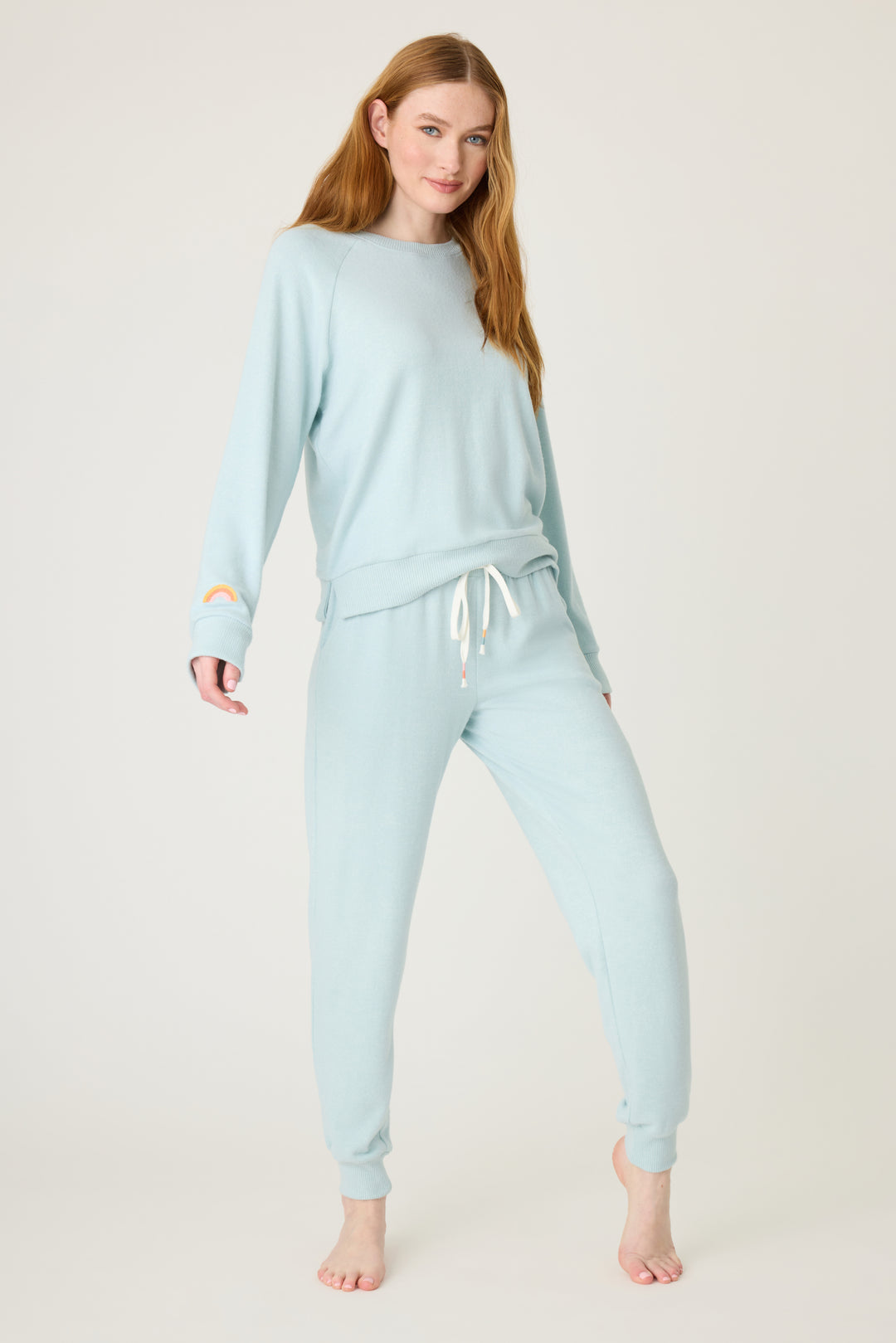 Women's blue melange lounge set top & jogger with small rainbow embroidery on cuff.