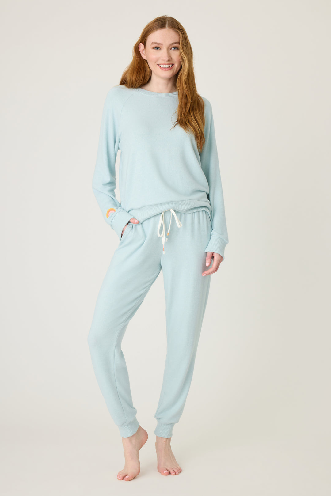 Women's blue melange lounge set top & jogger with small rainbow embroidery on cuff.