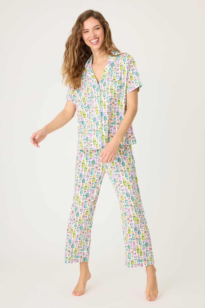 Women's breathable cotton-modal jersey short sleeve pajama set in ivory with multi lipstick print. With teal contrast piping & tie. Button-front top & open leg pant.