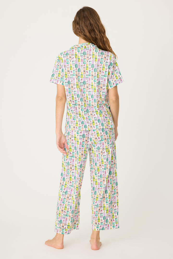 Women's breathable cotton-modal jersey short sleeve pajama set in ivory with multi lipstick print. With teal contrast piping & tie. Button-front top & open leg pant.