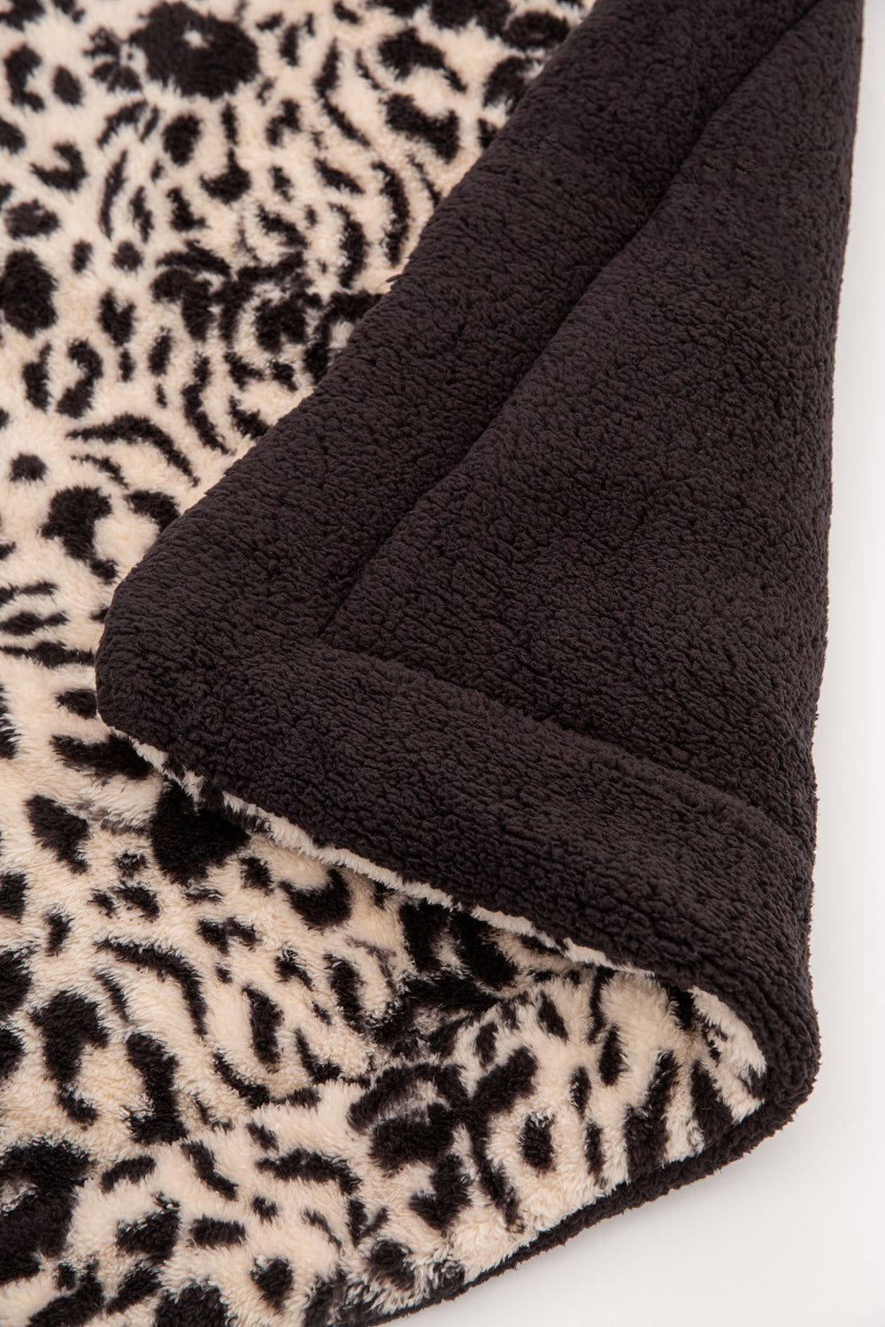 Tan-black leopard printed dog blanket is reversible to dark grey faux shearling back. Rolled in carry strap. (6889064923236)