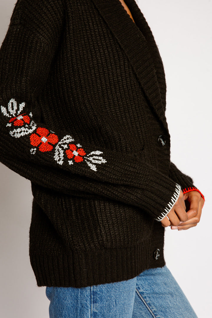 Black cardigan sweater, shawl collar, 3-button close & front pockets. Love & floral sleeve embroideries. (7325665067108)
